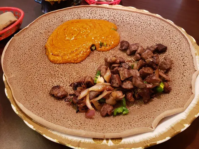 Gohe Ethiopian Restaurant signature dishes - Traditional Ethiopian meat and veggie platters with injera in Winnipeg